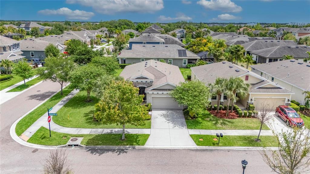 6309 Shadowlake Drive Apollo Beach, FL 33572 - Photo 48 of 64 an aerial view of a house with a garden and a car parked