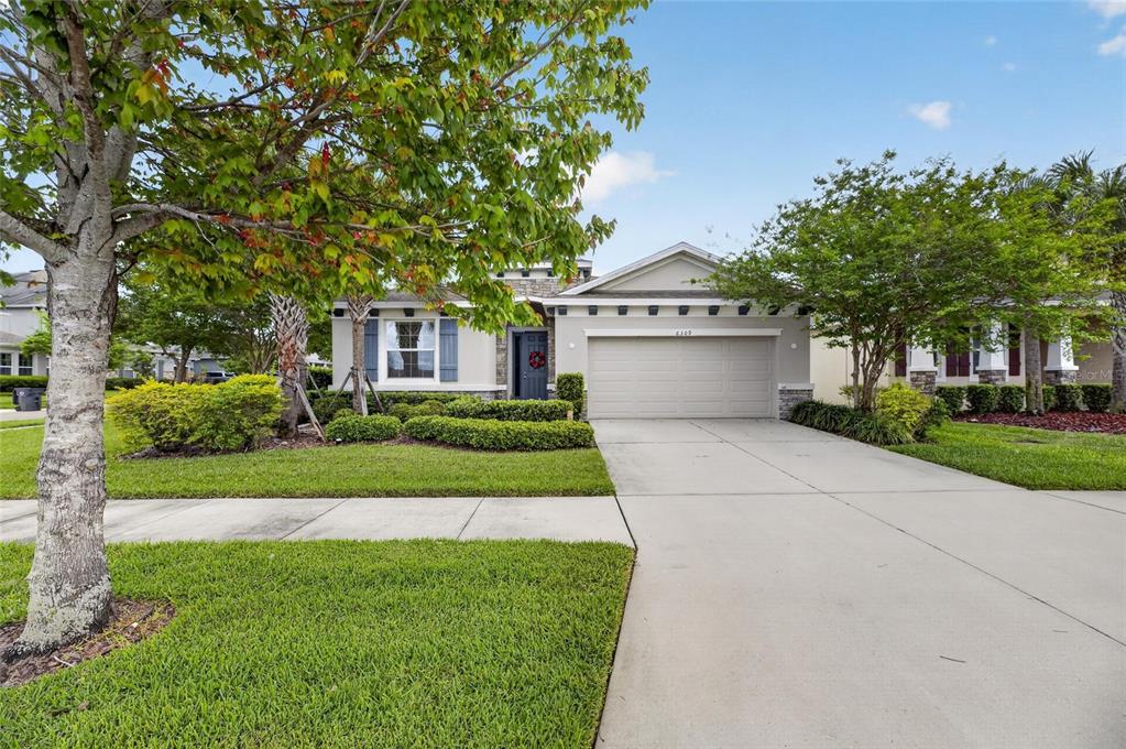 6309 Shadowlake Drive Apollo Beach, FL 33572 - Photo 50 of 64 a front view of a house with a yard and garage