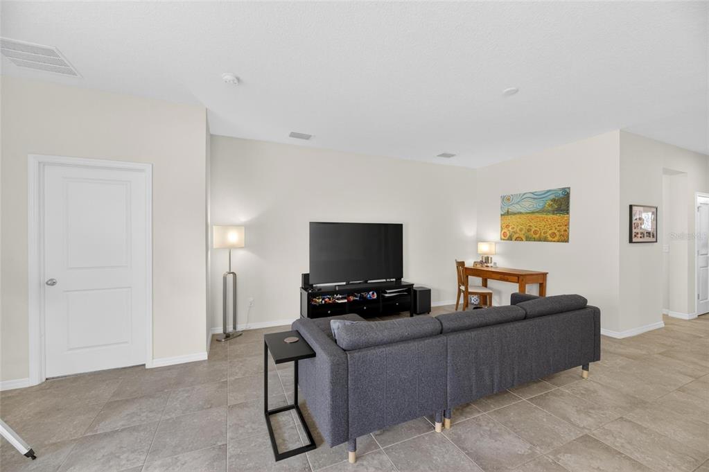 6309 Shadowlake Drive Apollo Beach, FL 33572 - Photo 6 of 64 a living room with furniture and a flat screen tv