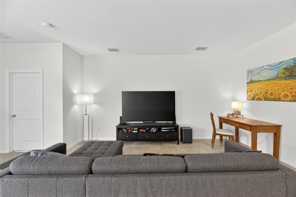 6309 Shadowlake Drive Apollo Beach, FL 33572 - Photo 7 of 64 a living room with furniture and a flat screen tv