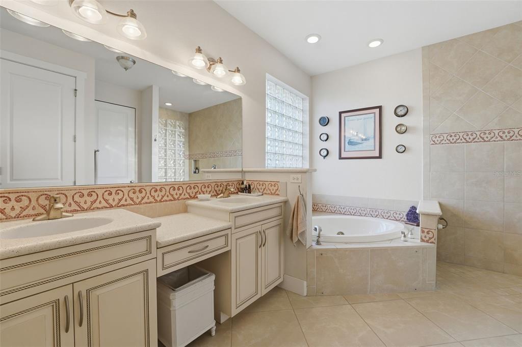 3260 Peace River Drive Punta Gorda, FL 33983 - Photo 25 of 59 a bathroom with a tub a sink double vanity and a mirror