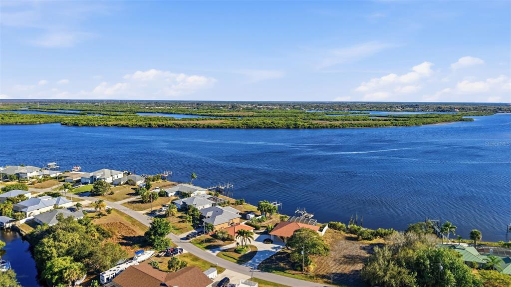 3260 Peace River Drive Punta Gorda, FL 33983 - Photo 53 of 59 a view of a lake with a building in the back