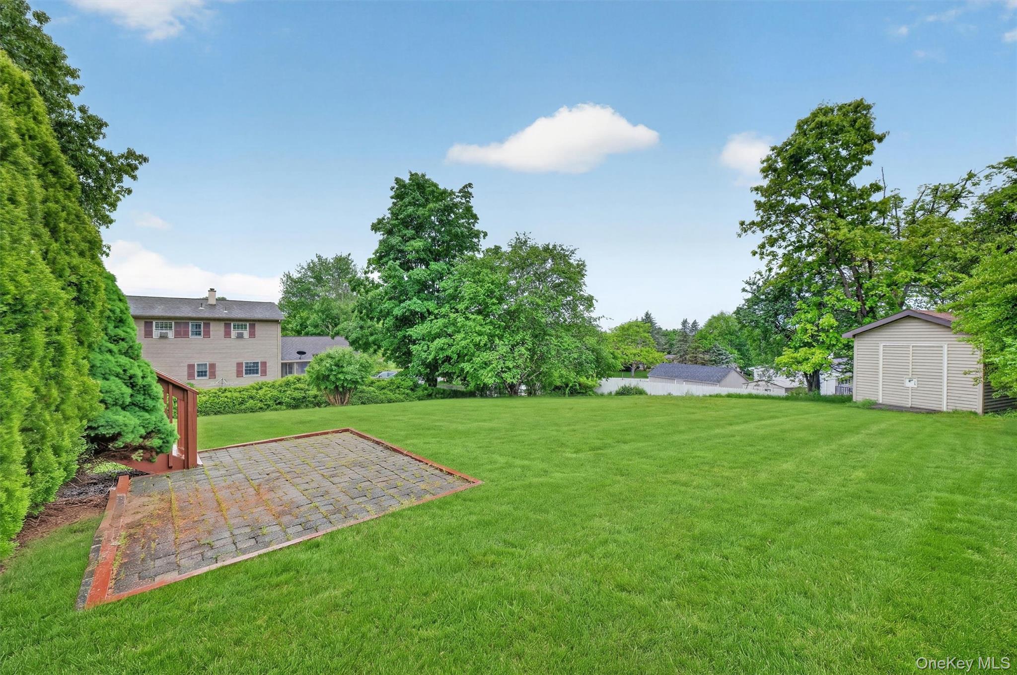 1 Rockledge Road Poughkeepsie, NY 12601 - Photo 30 of 36 Expansive rear lawn with a paver patio and a utility shed