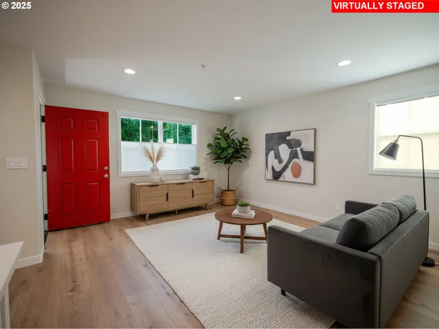 a living room with furniture a window and a flat screen tv