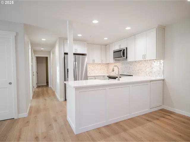 a kitchen with stainless steel appliances granite countertop a refrigerator sink and cabinets