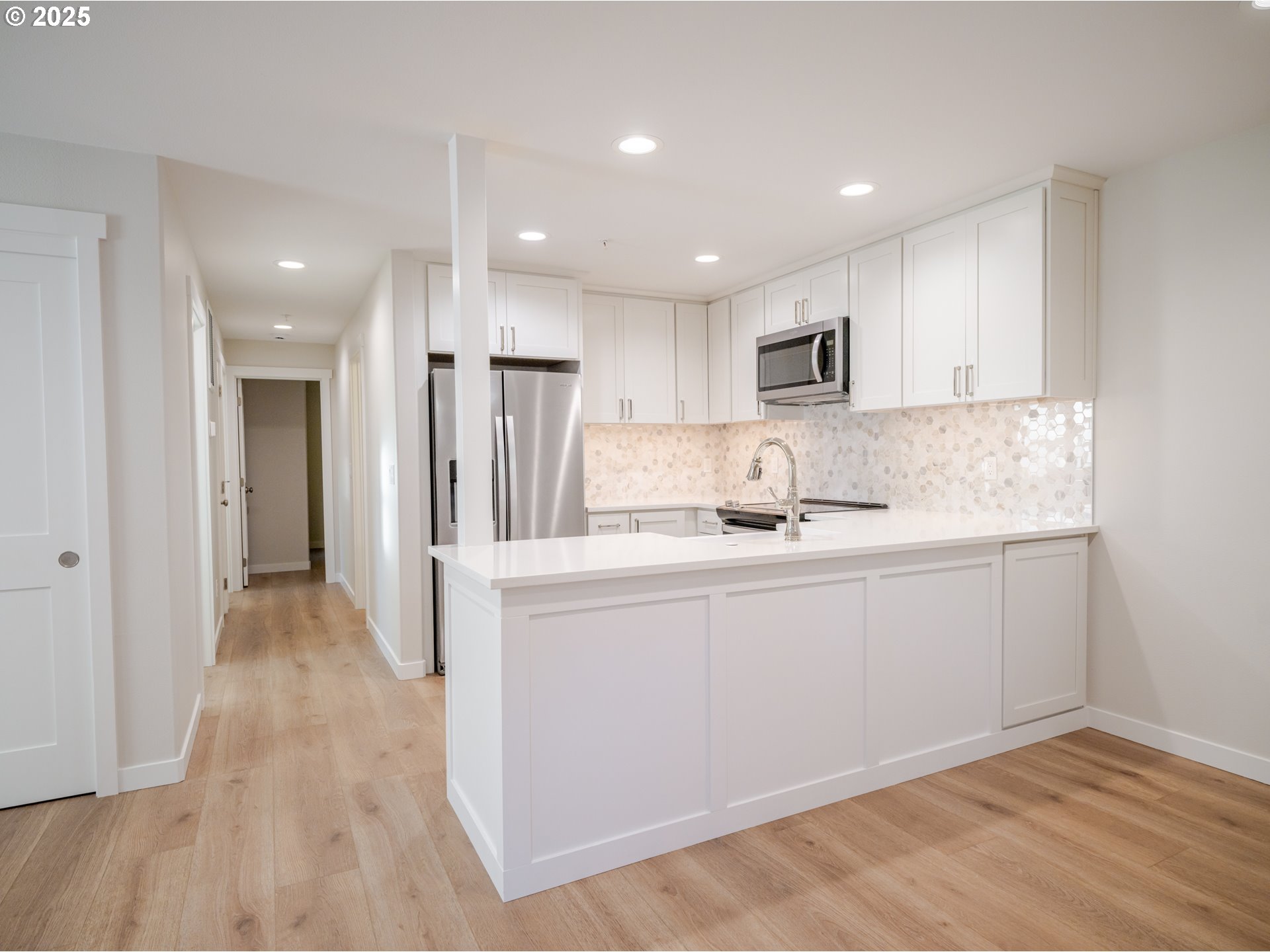 420 Elk Creek Road, Unit 401 Cannon Beach, OR 97110 - Photo 14 of 31 a kitchen with stainless steel appliances granite countertop a refrigerator sink and cabinets