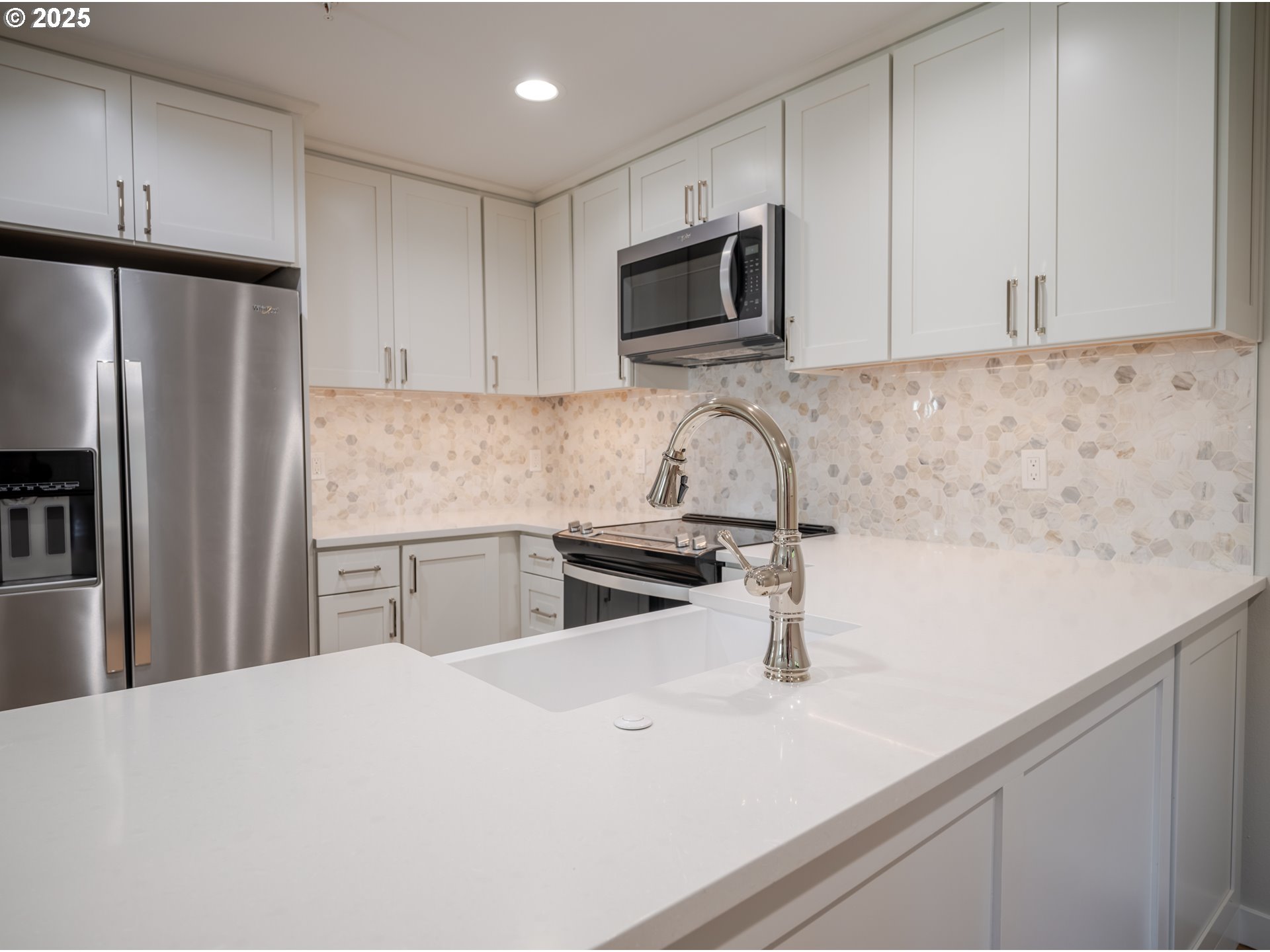 420 Elk Creek Road, Unit 401 Cannon Beach, OR 97110 - Photo 16 of 31 a kitchen with stainless steel appliances a sink a stove a microwave and refrigerator