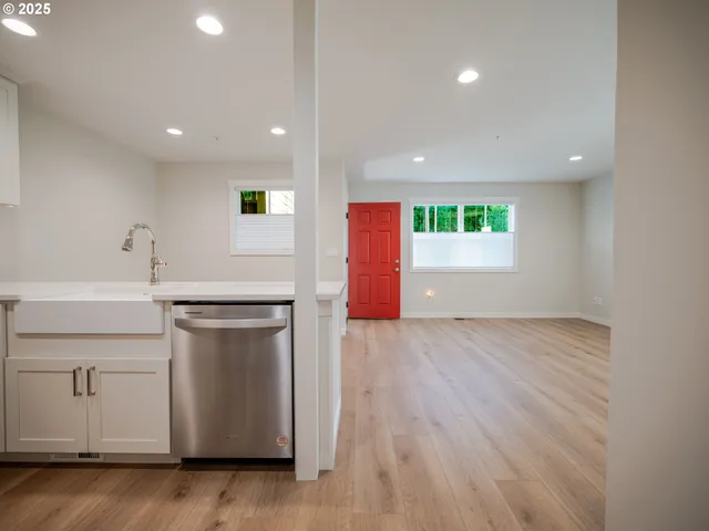 a kitchen with a sink cabinets and wooden floor