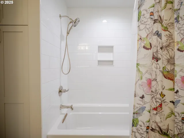 a bathroom with a bathtub and shower