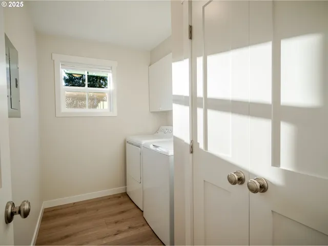 a view of a room with wooden floor and windows