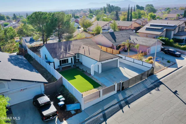 an aerial view of a house with swimming pool patio and mountain view