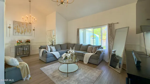 a living room with furniture fireplace and a chandelier
