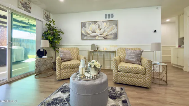 a living room with furniture and a large window with outer view