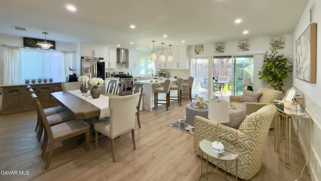 a living room with lots of furniture and kitchen view