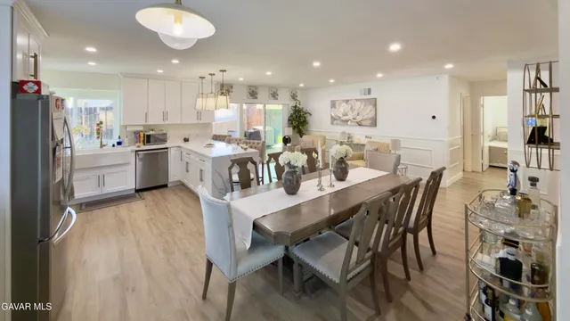 a large kitchen with a table and chairs