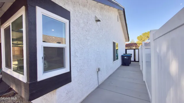 a view of a swimming pool with a patio and backyard