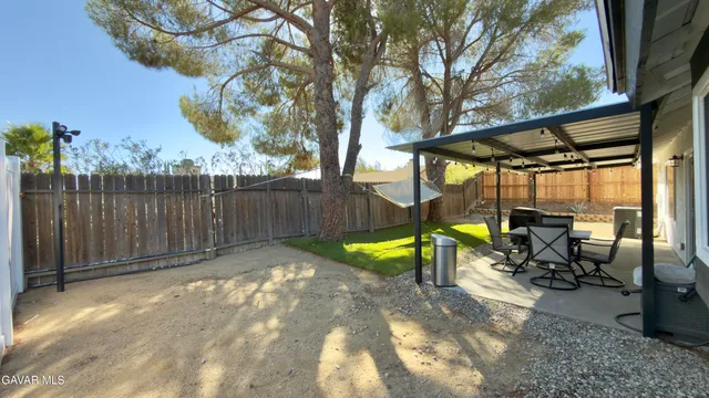 a view of a house with backyard porch and sitting area