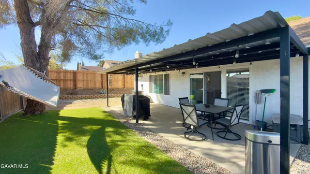 a view of a house with backyard porch and sitting area