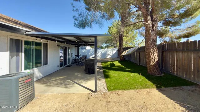 a view of a house with backyard porch and sitting area