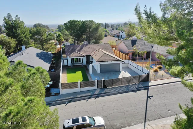 an aerial view of residential houses with yard and swimming pool