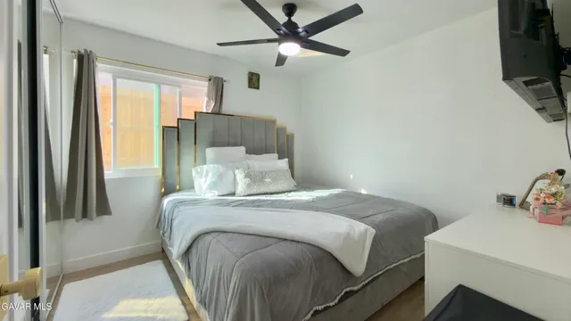 a bedroom with a bed and a tv