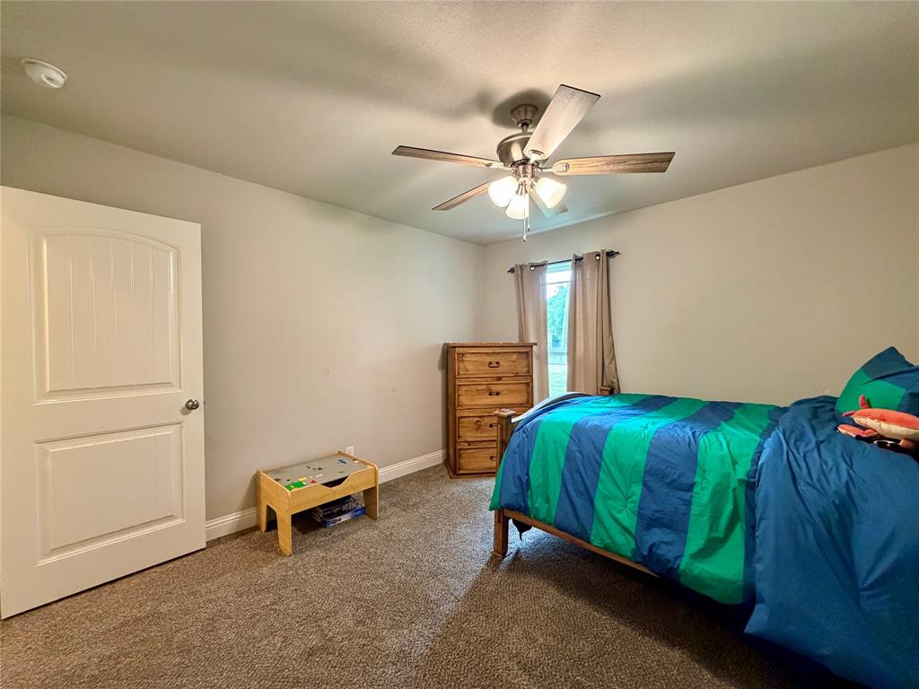 619 Mansfield Road Cleburne, TX 76031 - Photo 11 of 19 Neutral wall color with textured carpeting