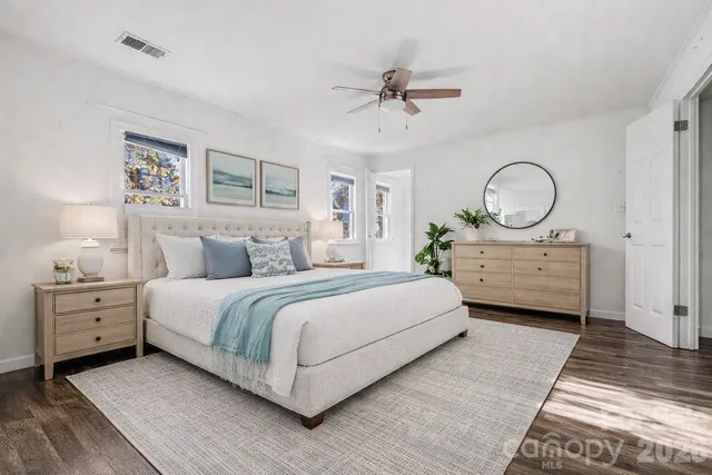 a bedroom with a large bed and a chandelier