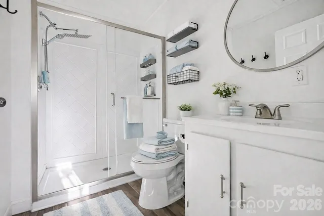 a bathroom with a mirror and a shower