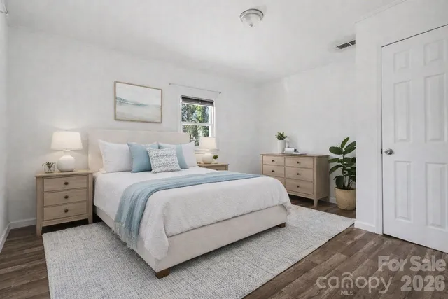 a bedroom with a bed and a lamp