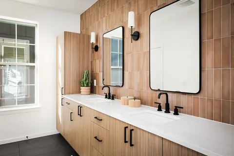 a bathroom with a double vanity sink and mirror