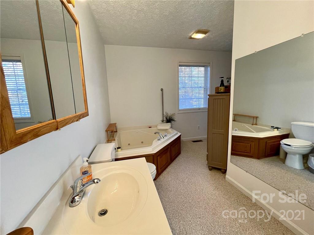 85 Moore Road Tryon, NC 28782 - Photo 11 of 20 a bathroom with a sink toilet and shower