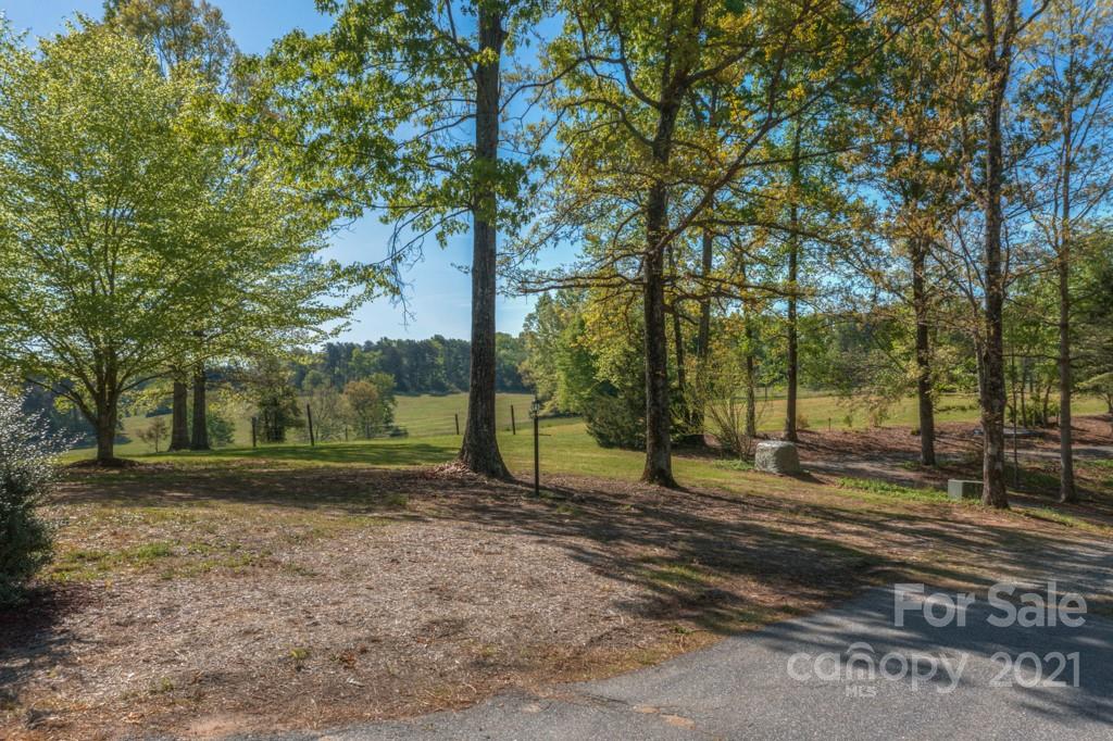 85 Moore Road Tryon, NC 28782 - Photo 18 of 20 a backyard of a house with lots of green space