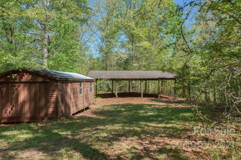 85 Moore Road Tryon, NC 28782 - Photo 19 of 20 a view of a backyard with a small cabin