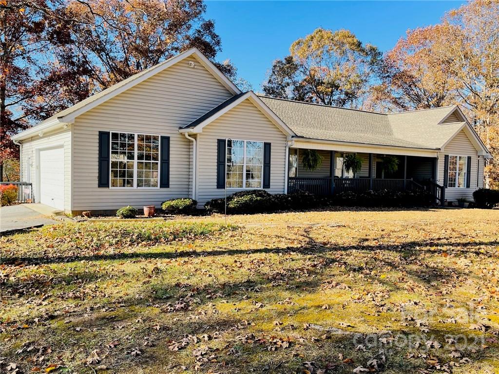 85 Moore Road Tryon, NC 28782 - Photo 3 of 20 a front view of a house with a yard covered with snow