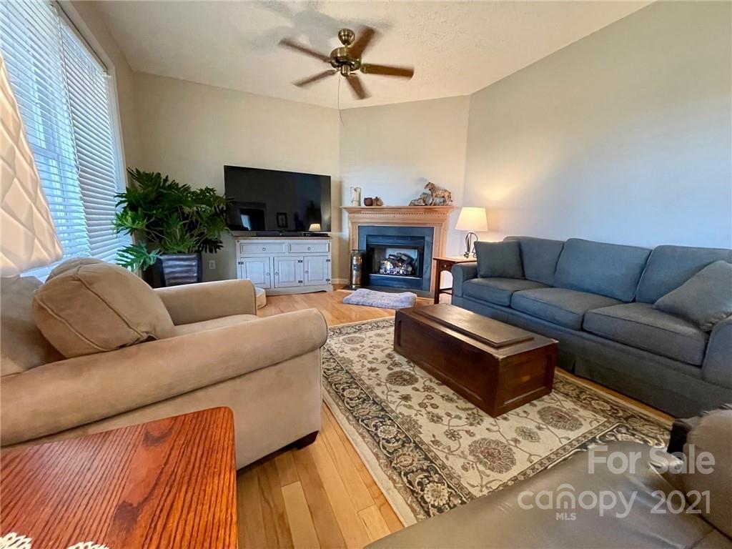 85 Moore Road Tryon, NC 28782 - Photo 6 of 20 a living room with furniture a flat screen tv and a fireplace