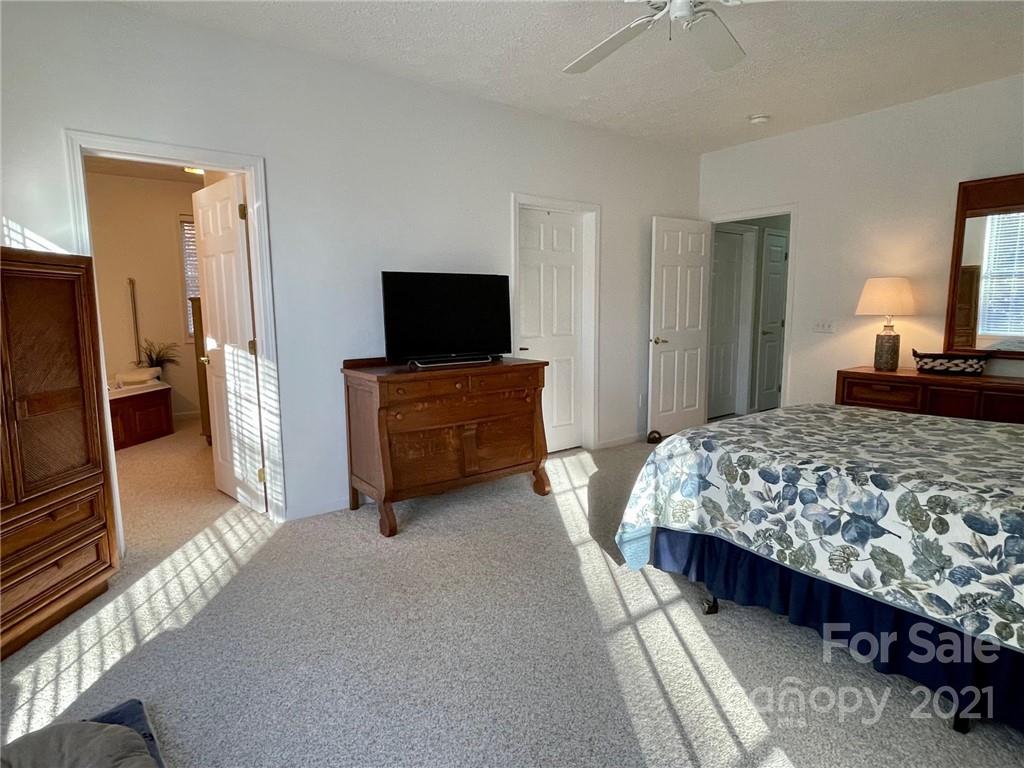 85 Moore Road Tryon, NC 28782 - Photo 10 of 20 a bedroom with a bed and a flat screen television