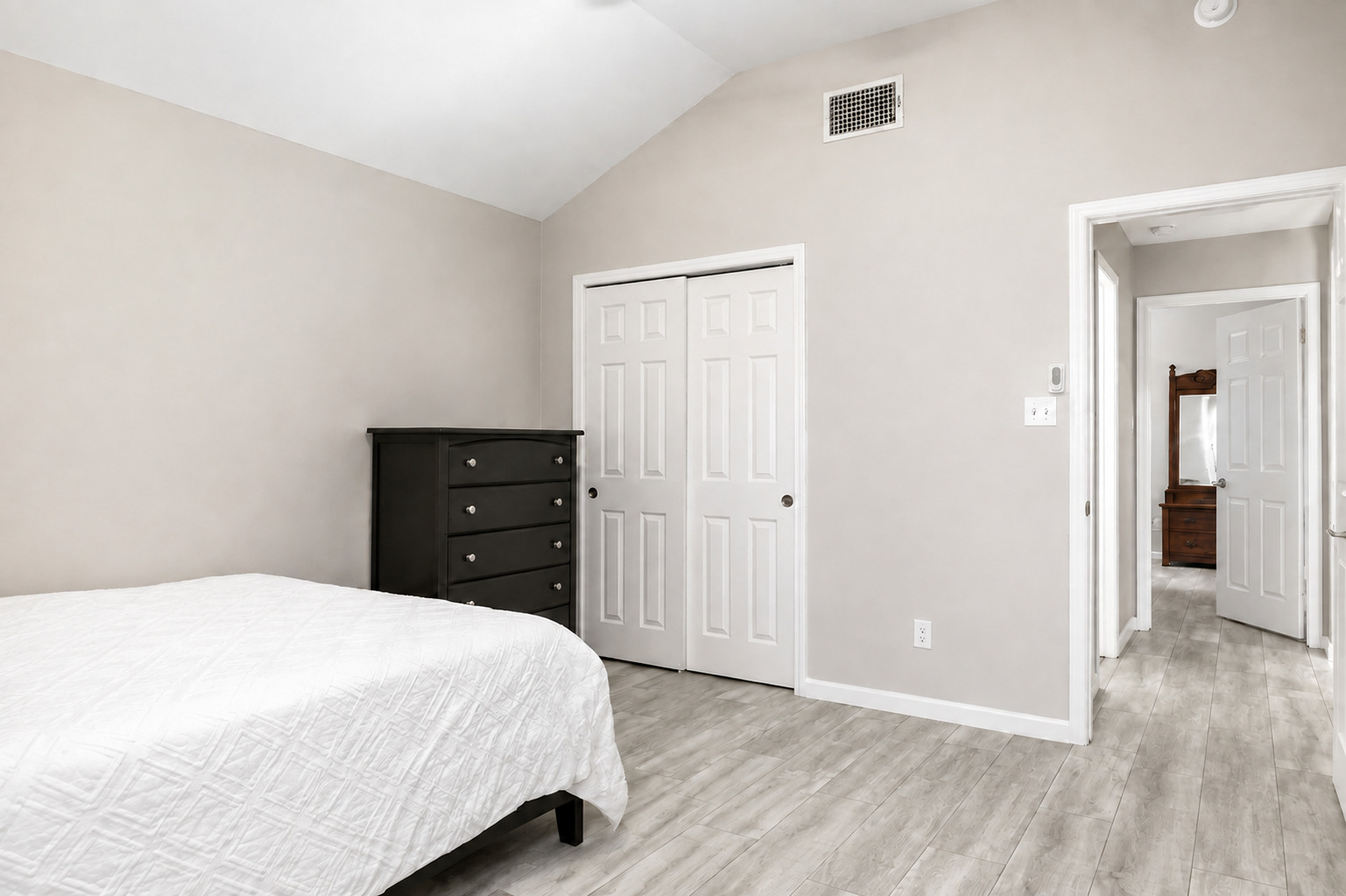 1921 Rutherford Drive Leander, TX 78641 - Photo 16 of 29 Vaulted ceilings and wood-texture flooring highlight this serene, functional bedroom space. Virtually Staged.