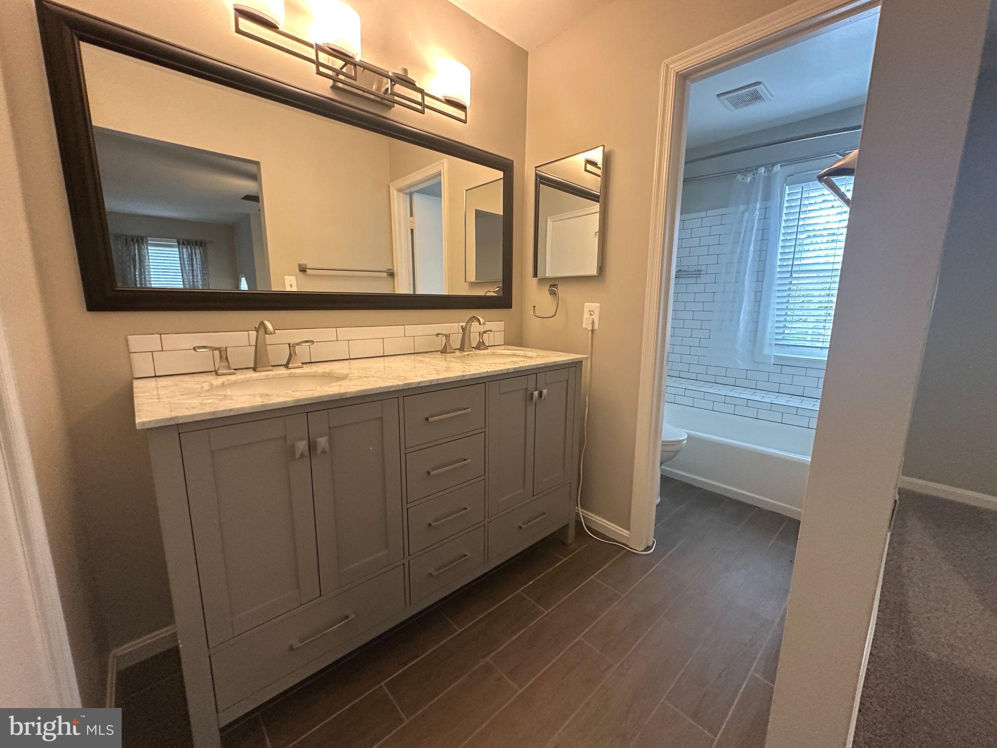 11928 Sentinel Point Court Reston, VA 20191 - Photo 15 of 23 Elegant dual-sink bathroom retreat.
