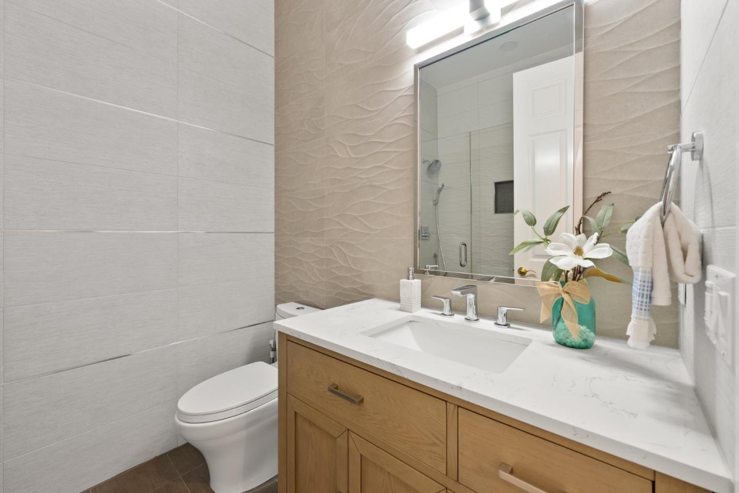 1173 Elysian Place San Jose, CA 95125 - Photo 25 of 60 a bathroom with a sink a toilet and mirror