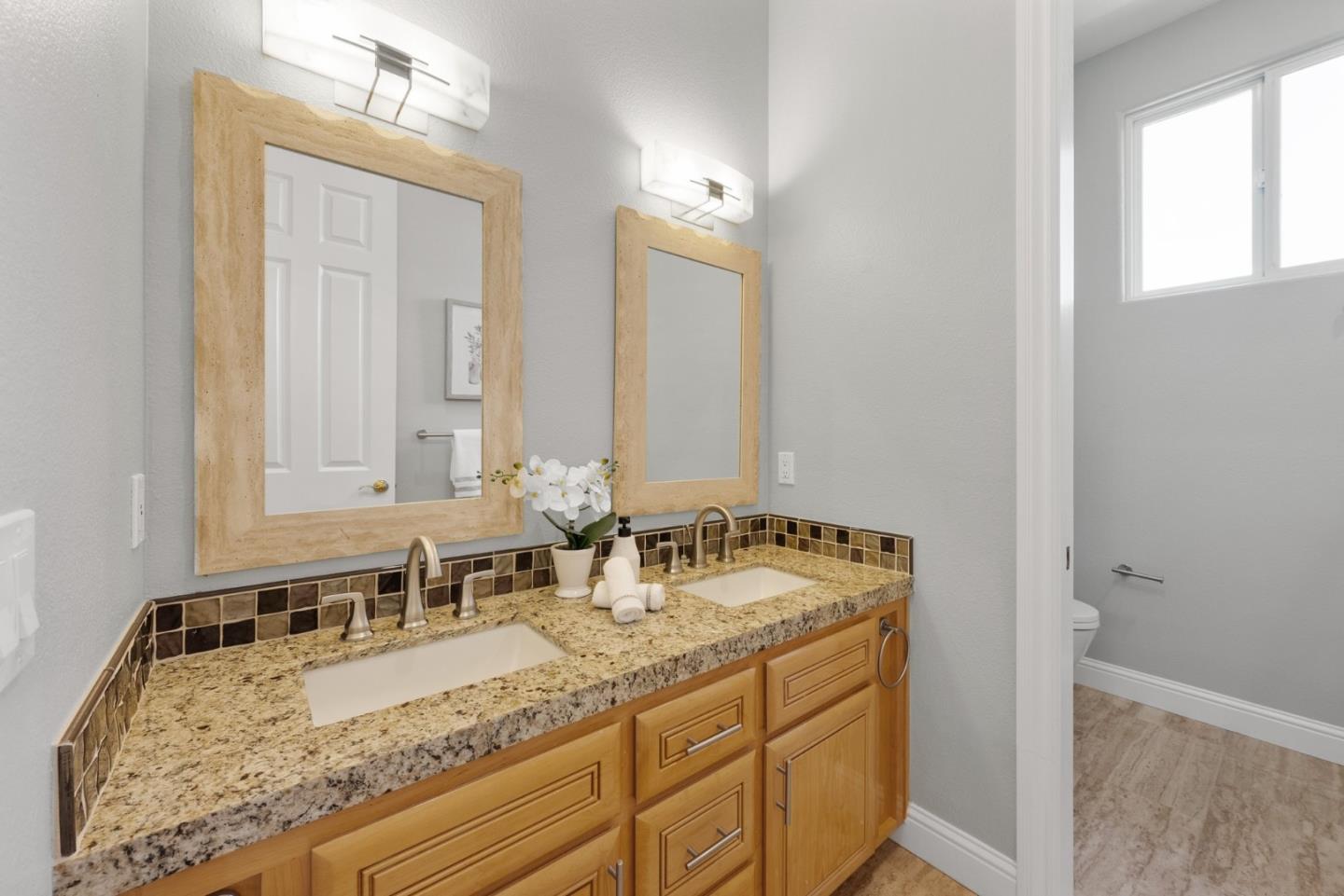 1173 Elysian Place San Jose, CA 95125 - Photo 40 of 60 a bathroom with a granite countertop sink and a mirror