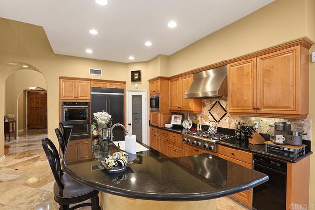 a kitchen with a table chairs stove and refrigerator