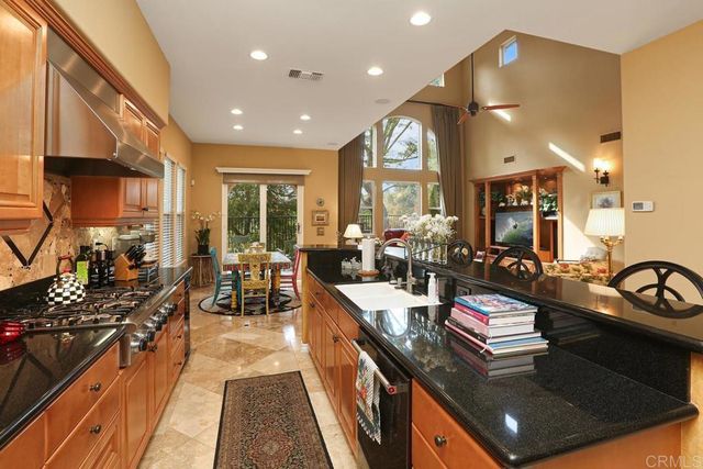 a kitchen with sink stove and cabinets