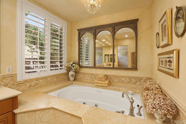 a bathroom with bathtub and windows