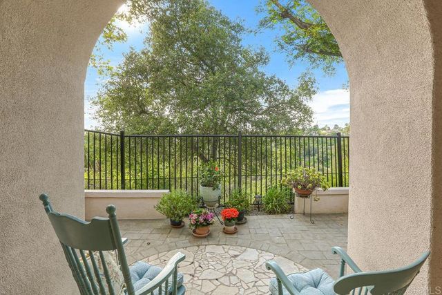 a balcony with furniture and a potted plant