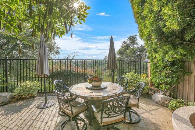 a table and chairs in patio of a lake view