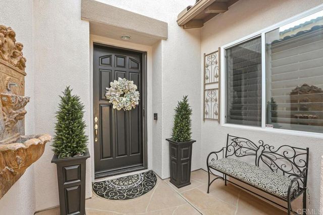 a front view of a house with outdoor seating