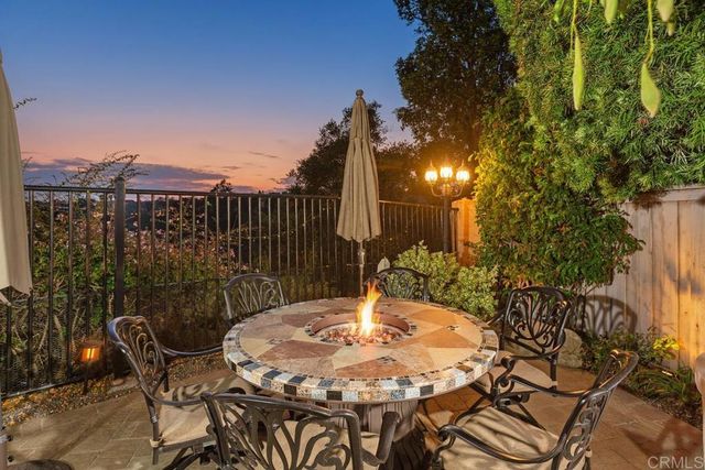 a view of a chairs and table in backyard