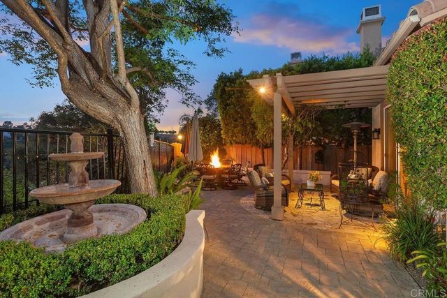 a view of a patio with table and chairs and potted plants