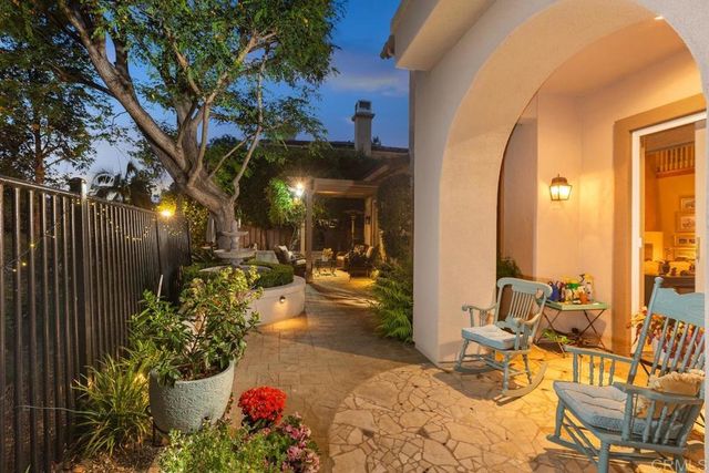 a view of a patio with dining table and chairs potted plants