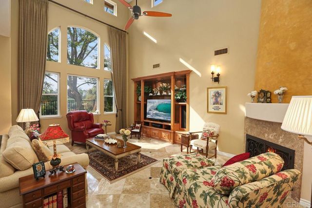 a living room with furniture large window and rug